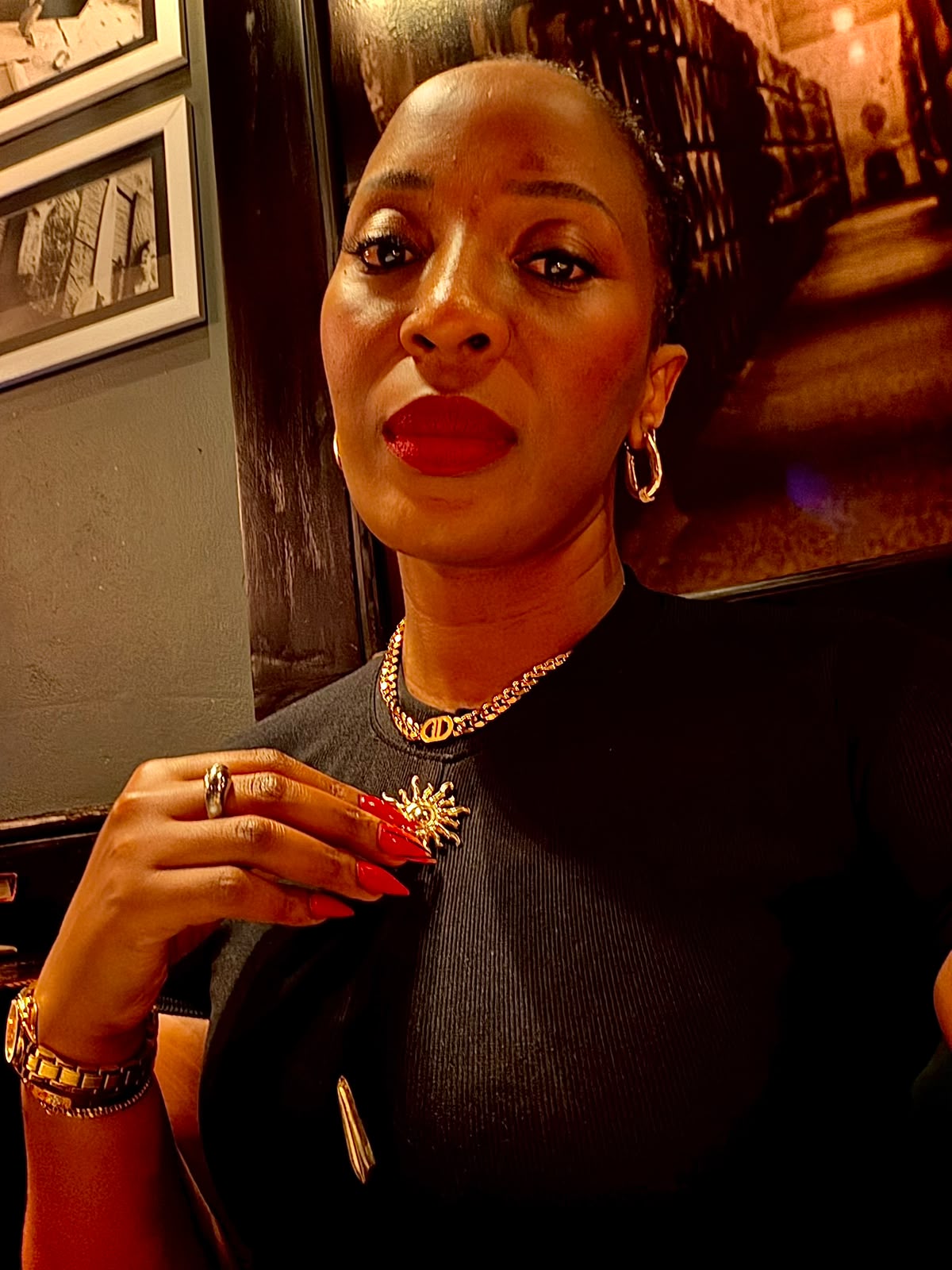 Jerrita in a black dress with gold jewellery